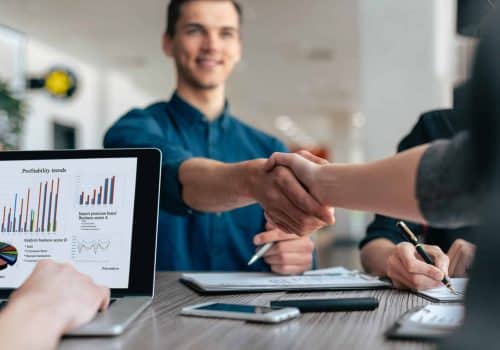 close up. young people greeting each other at the work table. concept of cooperation .